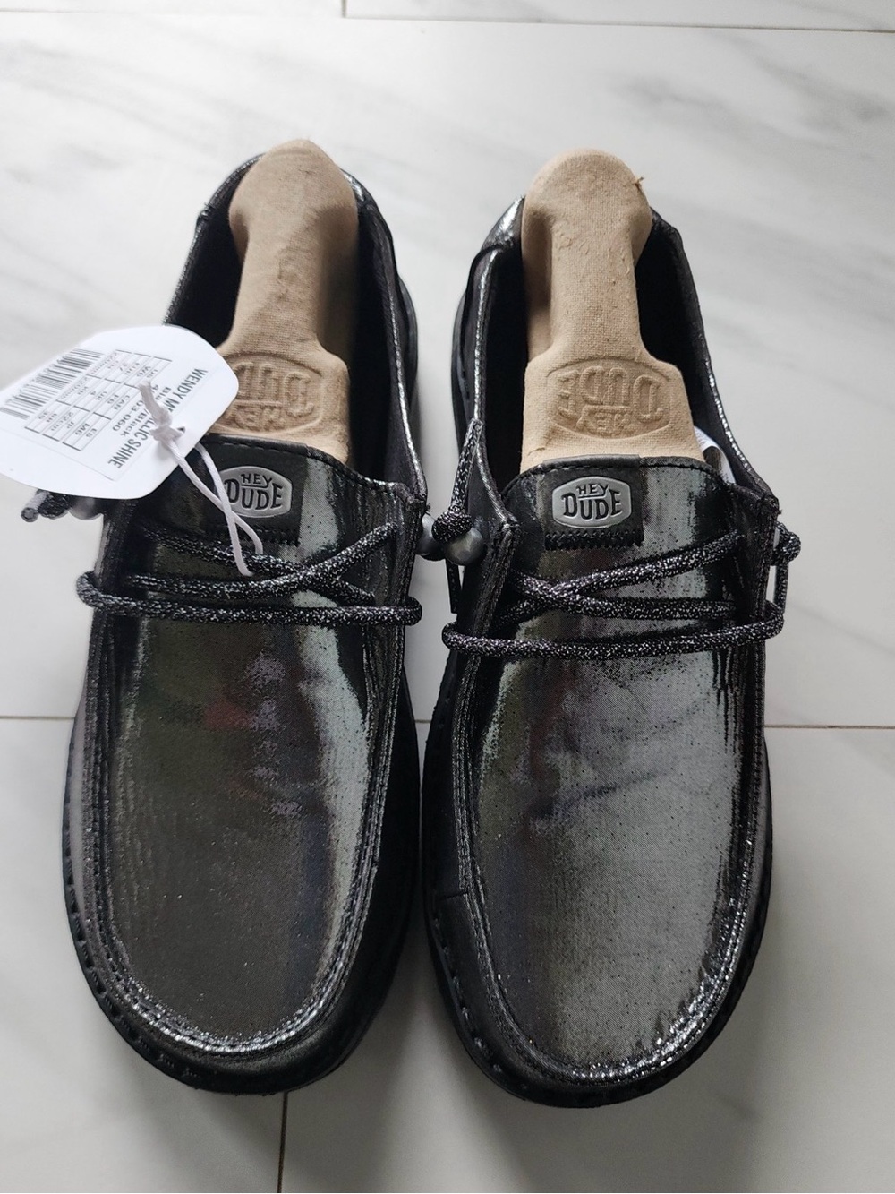 Heydudes Wendy metallic shine slip on shoe, featuring a dark, shimmering finish